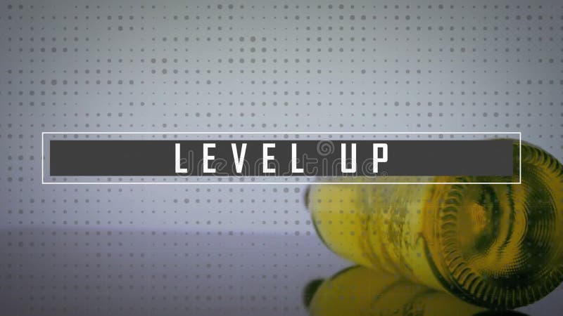 Glitching text showing LEVEL UP while yellow bottle rolling left on tabletop under dotted backdrop stock footage