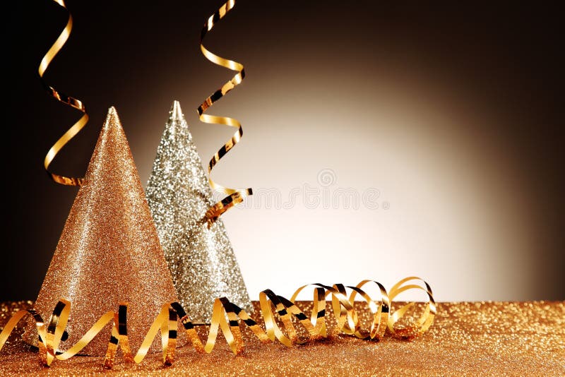 Close up Glittery Table with Glittery Silver and Gold Cone Hats and Streamers on Gradient Brown Background. Emphasizing Copy Space. Wedding cone stock images, royalty-free photos and pictures