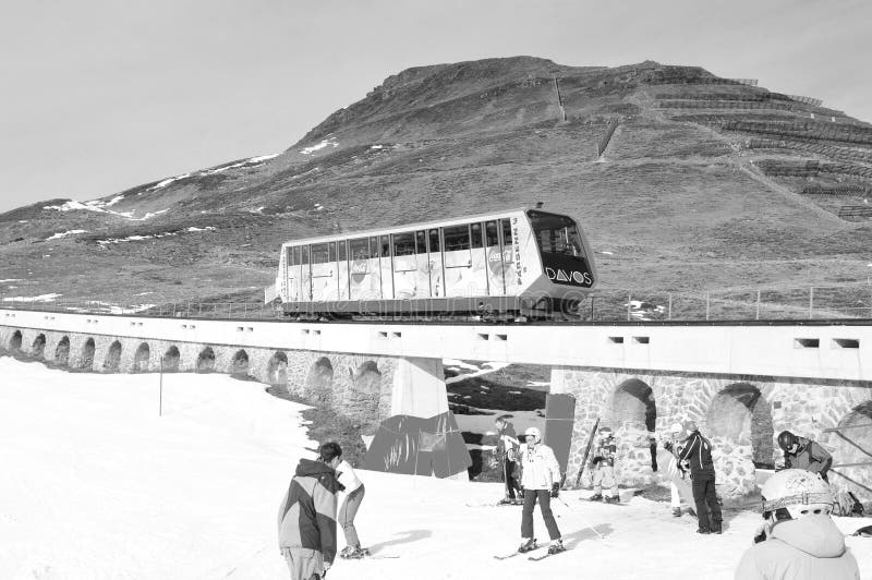 Global climate change: Snowboarder testing artificial snow at Parsenn above Davos city stock photo