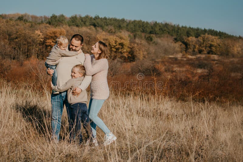 Global Day of Parents. Happy family enjoying together on a sunny day in country. father, mother and two boy children having fun