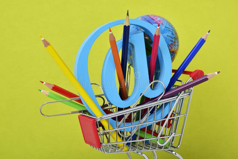Globe, colored pencils and at sign in a shopping cart royalty free stock image Globe, colored pencils and at sign in a shopping cart royalty free stock image