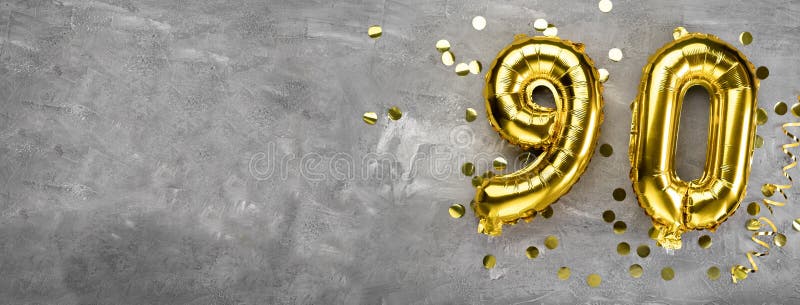 Yellow foil balloon number, number ninety on a concrete background. Greeting card with the inscription 90. Anniversary concept. for anniversary, birthday, new year celebration. banner, copy space. Yellow foil balloon number, number ninety on a concrete background. Greeting card with the inscription 90. Anniversary concept. for anniversary, birthday, new year celebration. banner, copy space.