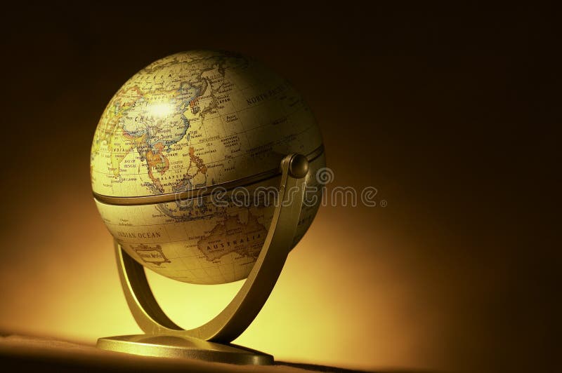 A vintage atlas globe shot with warm background. A vintage atlas globe shot with warm background