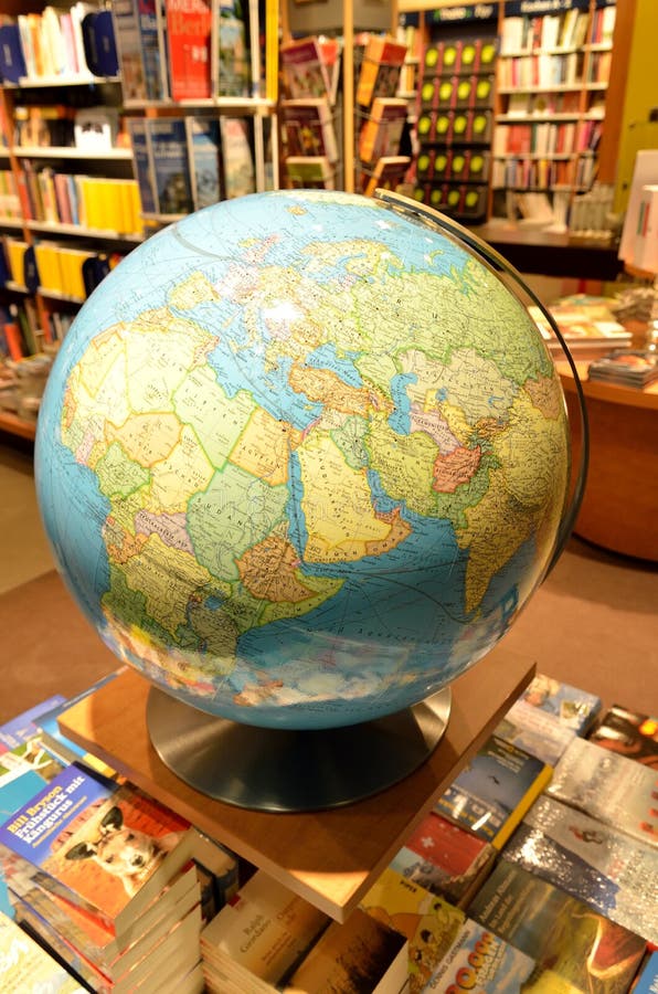 Earth globe. Big earth globe with different book on the shelves in the background, adventure, africa, around, atlas, blue, cartography, circle, continent, continents, destination, educate, education, educational, environment, equipment, europe, expedition, exploration, geography, global, globetrotter, holder, holidays, international, journey, knowledge, learn, learning, mainland, mainlands, map, miniature, model, navigation, navigational, object, one, parallel, parallels, place, planet, plastic, rack, scale, school, schooling, science, shape, shot, space, sphere, studio, study, symbol, teach, teacher, teaching, tool, tools, tourism, travel, traveler, traveling, trip, universal, vacation, vacations, voyager, white, world. Earth globe. Big earth globe with different book on the shelves in the background, adventure, africa, around, atlas, blue, cartography, circle, continent, continents, destination, educate, education, educational, environment, equipment, europe, expedition, exploration, geography, global, globetrotter, holder, holidays, international, journey, knowledge, learn, learning, mainland, mainlands, map, miniature, model, navigation, navigational, object, one, parallel, parallels, place, planet, plastic, rack, scale, school, schooling, science, shape, shot, space, sphere, studio, study, symbol, teach, teacher, teaching, tool, tools, tourism, travel, traveler, traveling, trip, universal, vacation, vacations, voyager, white, world