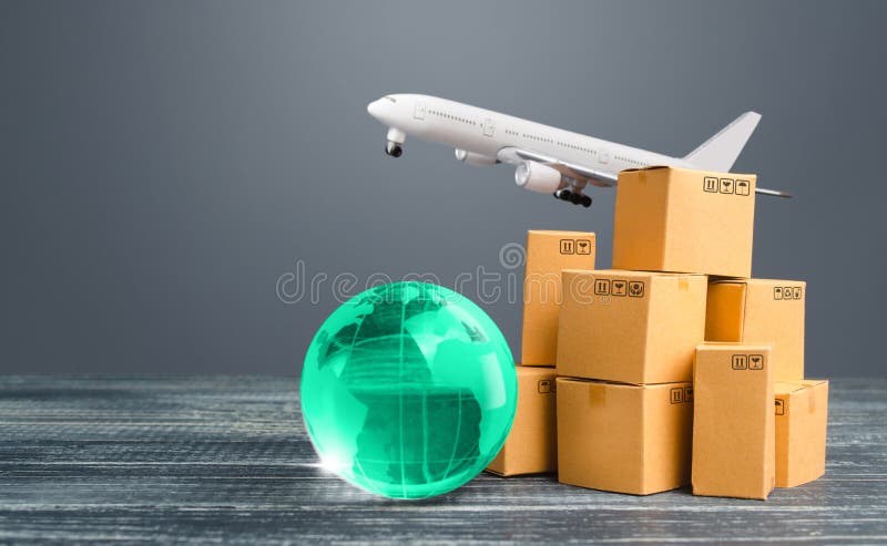 Light green globe near cardboard boxes and freight plane. International delivery of goods and products. Logistics, infrastructure hubs. Import, export. Economic relations commerce. Air transportation. Light green globe near cardboard boxes and freight plane. International delivery of goods and products. Logistics, infrastructure hubs. Import, export. Economic relations commerce. Air transportation