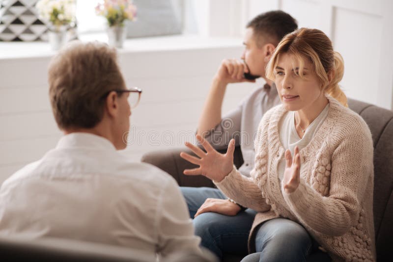 Gloomy blonde woman complaining about her husband stock photos Gloomy blonde woman complaining about her husband stock photos