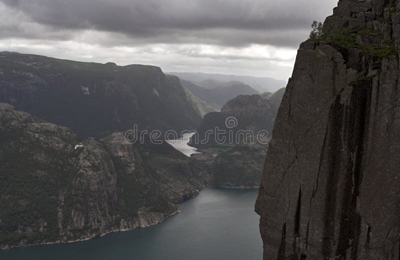 Gloomy fjord landscape - mountains cliffs and water