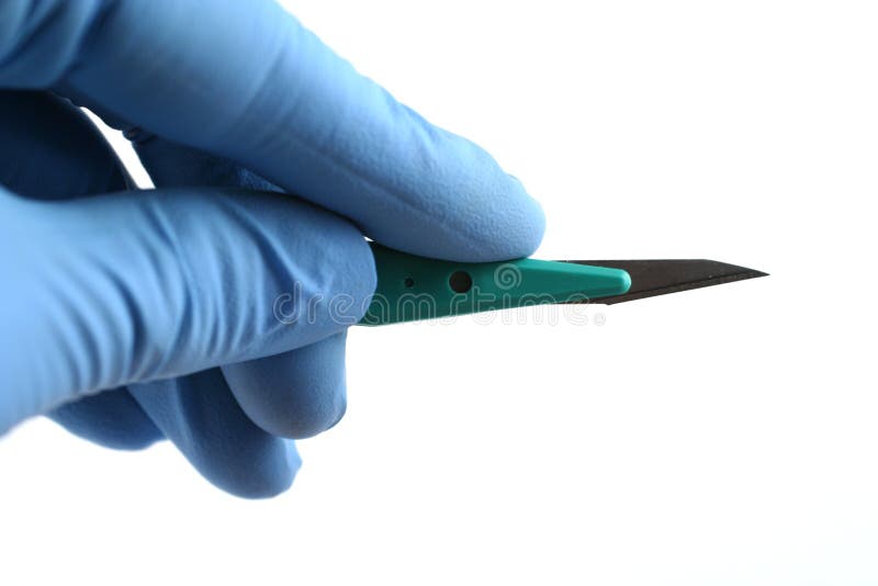 Gloved hand holding scalpel