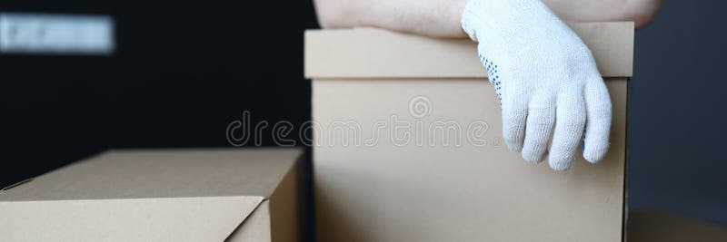 Gloved hands loader lie on cardboard boxes office royalty free stock images