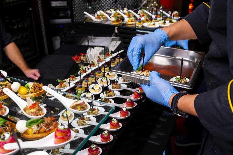 Gloved hands putting food stock photo. Image of kitchen - 129691624