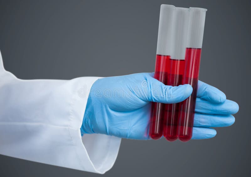 Gloved рука с красными трубками против серой предпосылки стоковая фотография Gloved рука с красными трубками против серой предпосылки стоковая фотография