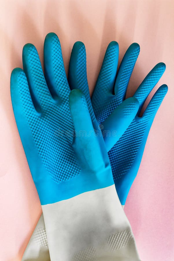 Gloves blue for cleaning and protection of hands, on pink background. garden work, work with the ground, aggressive cleaning royalty free stock photography Gloves blue for cleaning and protection of hands, on pink background. garden work, work with the ground, aggressive cleaning royalty free stock photography