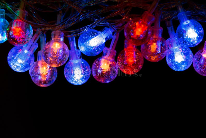 Glowing Blue and Red Christmas Lights on a Dark Background Stock Image