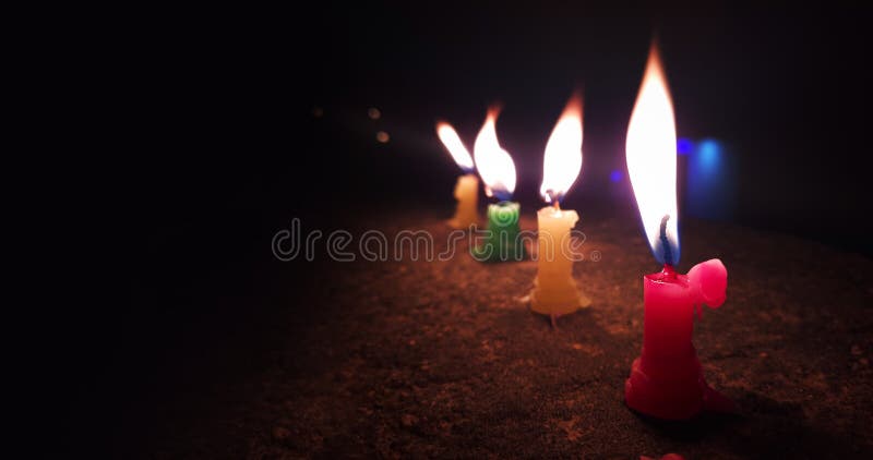 Glowing Candles Flame in Dark Black Background with Copy Space Stock