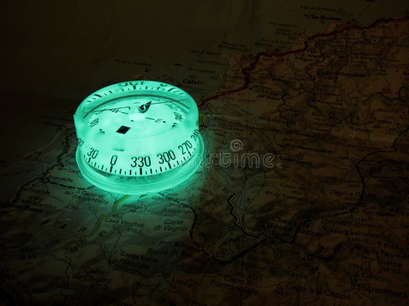 Glowing compass on a map royalty free stock photo Glowing compass on a map royalty free stock photo
