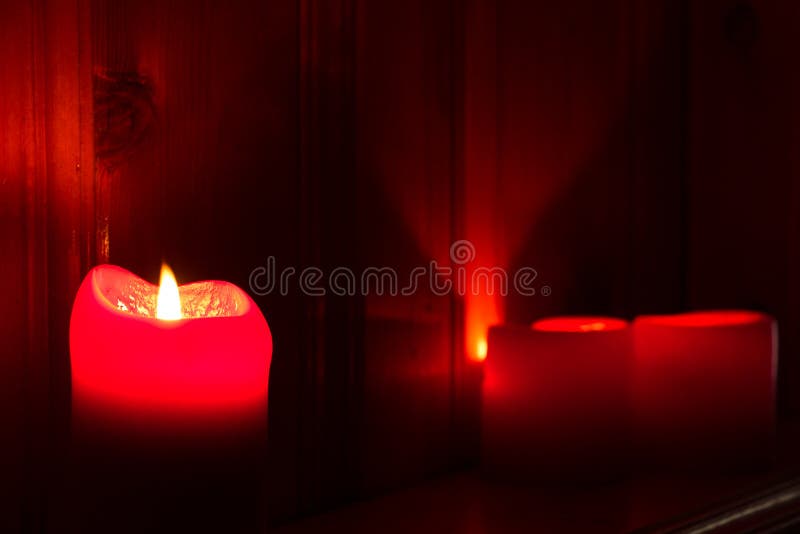 Glowing Red Candles stock image. Image of candlelit, candles 64333847