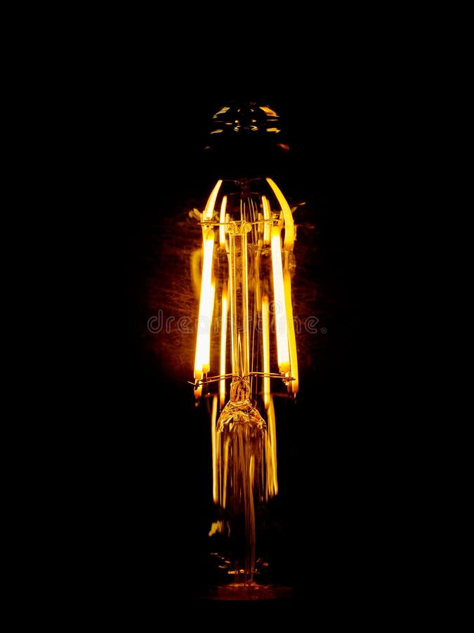 Glowing Spiral of an Incandescent Lamp Isolated on Black Stock Photo