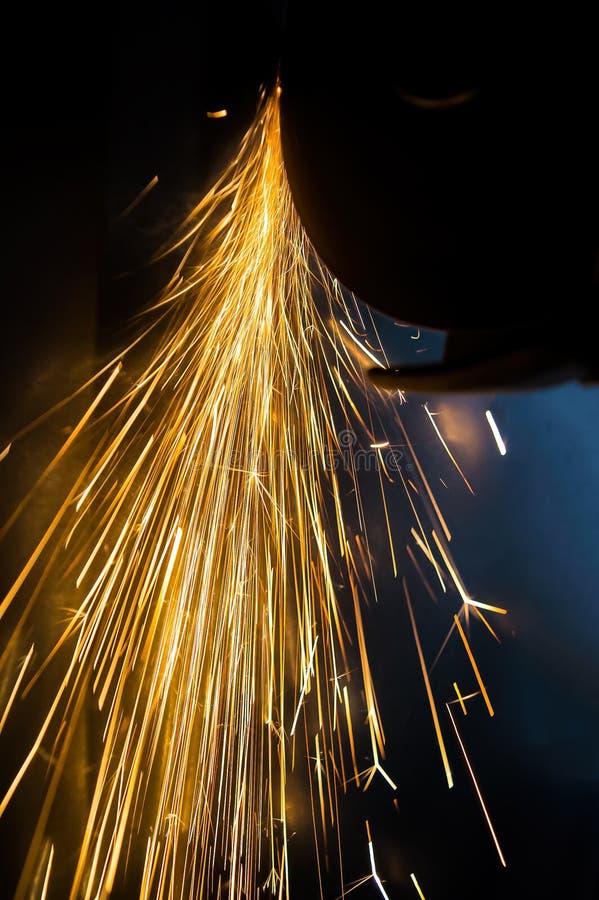 A Glowing Stream of Sparks from a Blade while Cutting Metal Stock Image