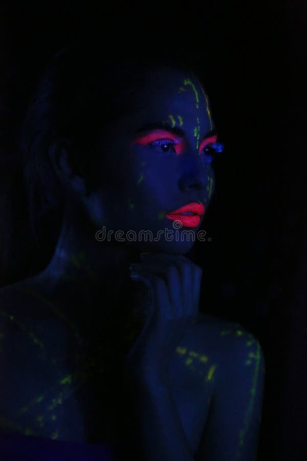 Glowing Woman Wearing UV Cosmetics Under Black Light Stock Image ...