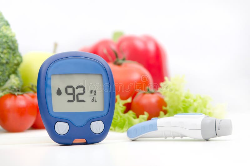 Glucometer e lancelet sul fondo delle verdure Sanità per il concetto del diabete