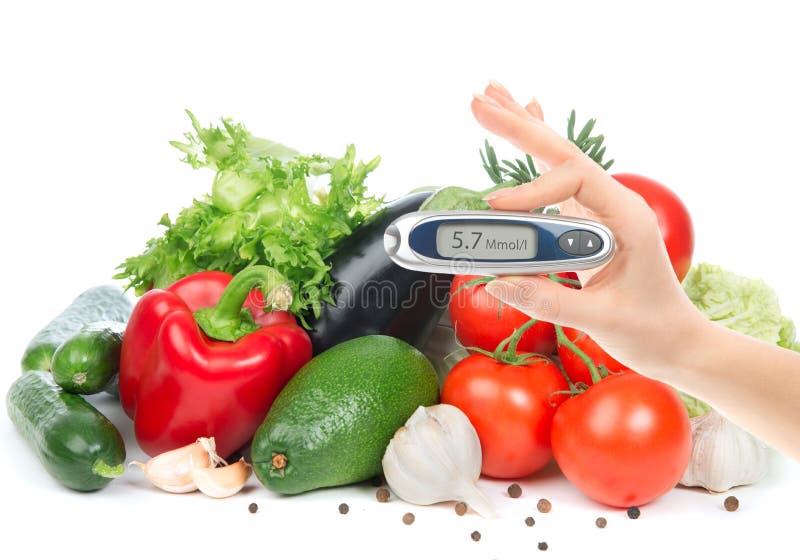 Diabetes concept glucometer for glucose level blood test in hand and healthy organic food on a white background. Diabetes concept glucometer for glucose level blood test in hand and healthy organic food on a white background