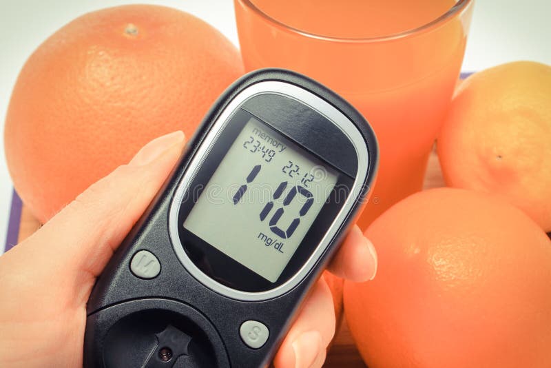 Glucose Meter with Result of Sugar Level and Fresh Natural Fruits