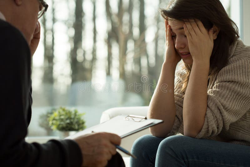 Glum girl during psychotherapy session