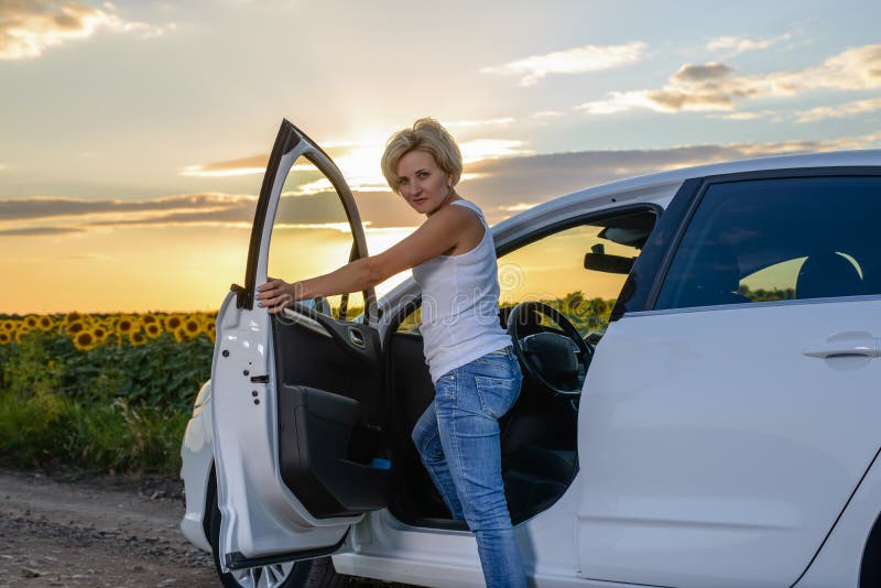 Glum woman sitting waiting for roadside assistance