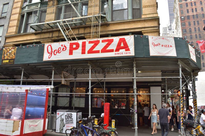 New York, USA - May 13 2023: Joe's Pizza, a beloved New York institution since 1975, continues to draw locals and tourists. New York, USA - May 13 2023: Joe's Pizza, a beloved New York institution since 1975, continues to draw locals and tourists