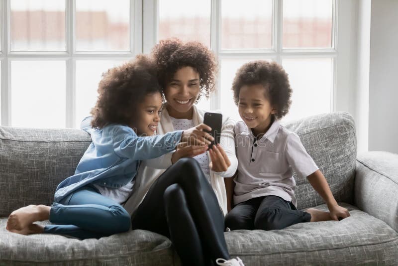 Glückliche Afroamerikanermutter und zwei nette Kinder stockbild