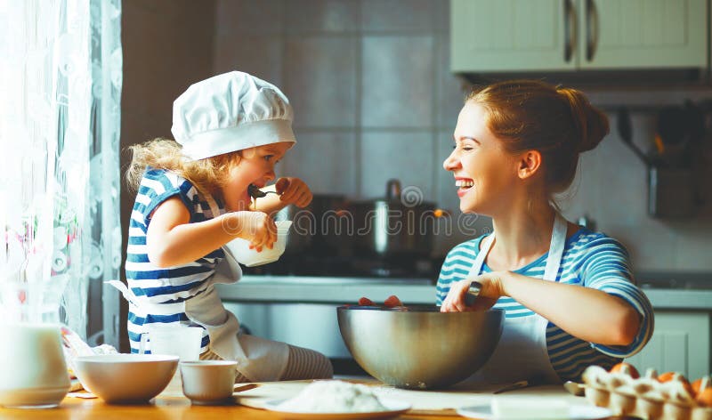 Happy family in the kitchen. mother and child daughter preparing the dough, bake cookies. Happy family in the kitchen. mother and child daughter preparing the dough, bake cookies