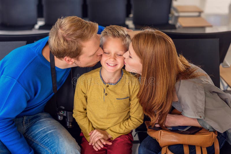 Glückliche Familie, die am Flughafen umarmt lizenzfreie stockfotos Glückliche Familie, die am Flughafen umarmt lizenzfreie stockfotos