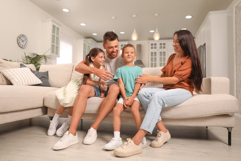Glückliche Familie mit Kindern, die sich auf dem Sofa amüsieren lizenzfreies stockbild
