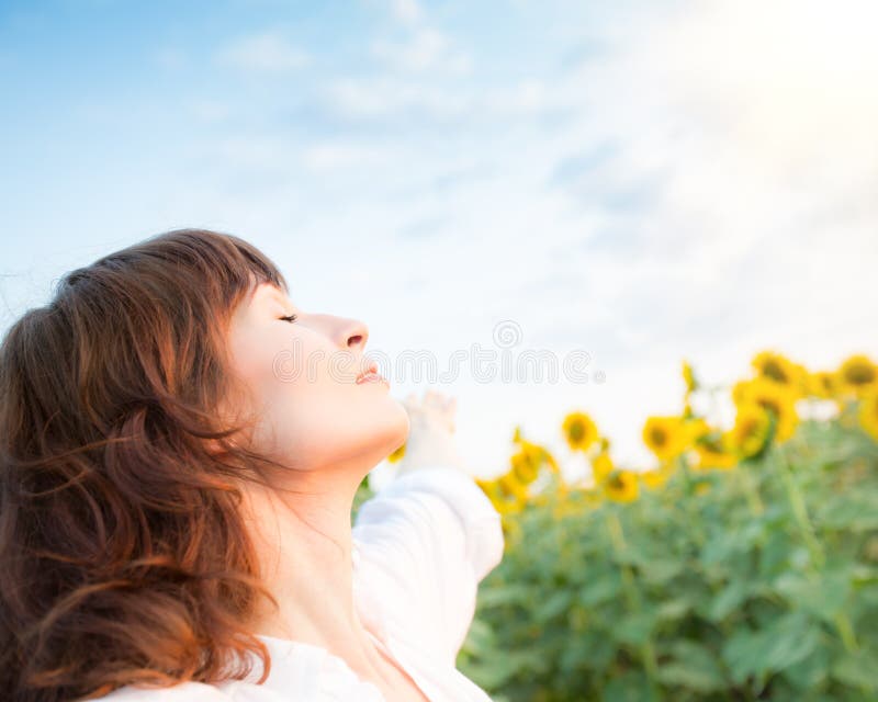 Glückliche Frau im Sonnenblumenfeld lizenzfreies stockbild Glückliche Frau im Sonnenblumenfeld lizenzfreies stockbild