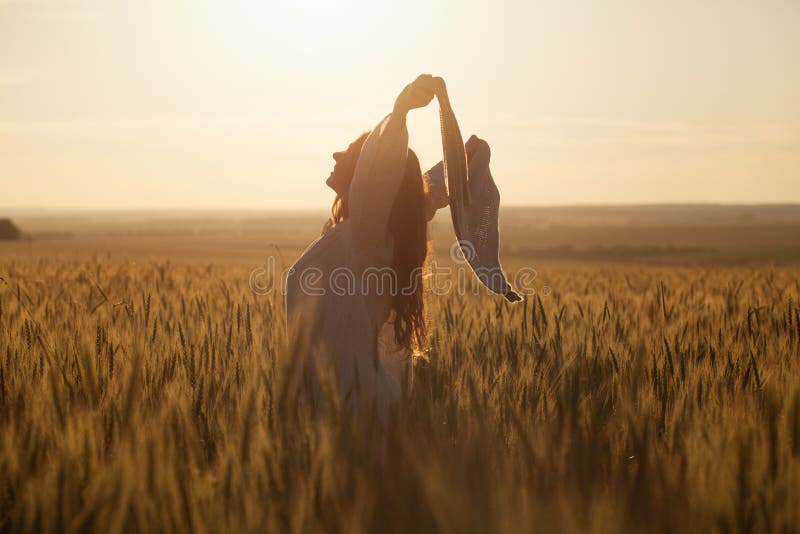 Happy young woman with a shawl in field. Happy young woman with a shawl in field