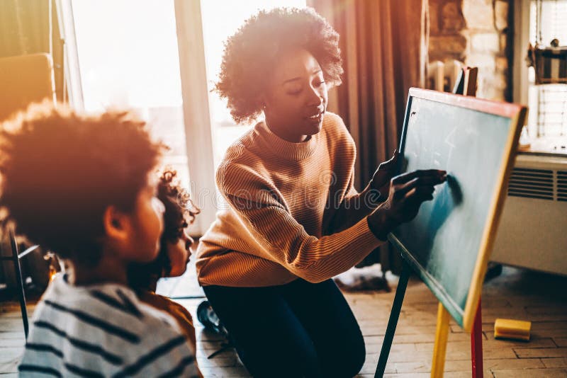 Glückliche Kinder lernen Mathematik mit Mutterlehrer zu Hause. Konzept für das Glück der Familie lizenzfreie stockbilder