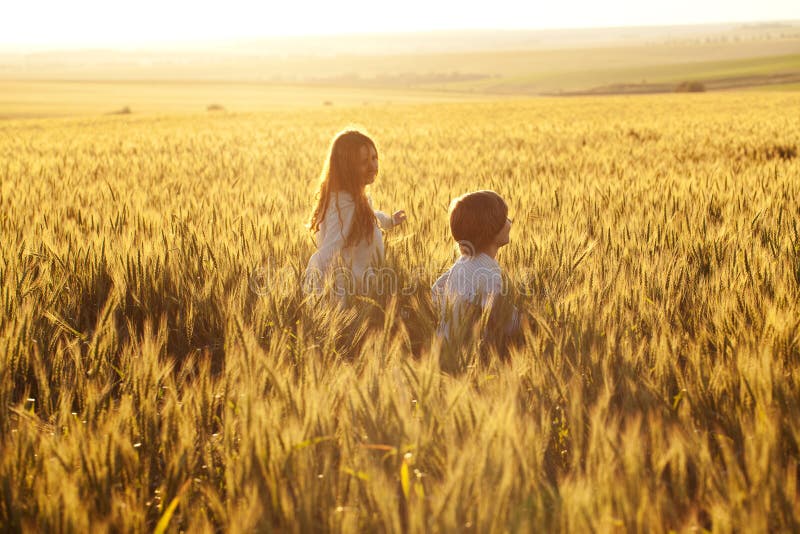 Happy mother and son are running through a wheat field. Happy mother and son are running through a wheat field