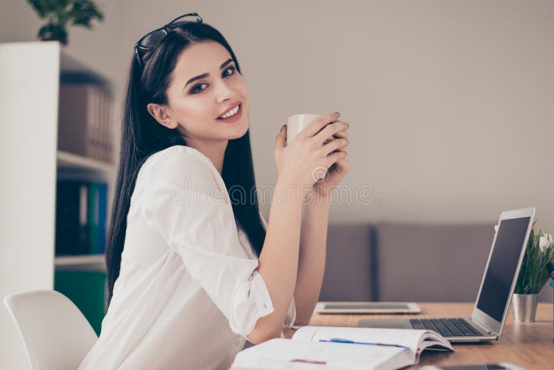 Glückliche schöne nette junge entspannte Geschäftsfrau, die an sitzt lizenzfreies stockfoto Glückliche schöne nette junge entspannte Geschäftsfrau, die an sitzt lizenzfreies stockfoto