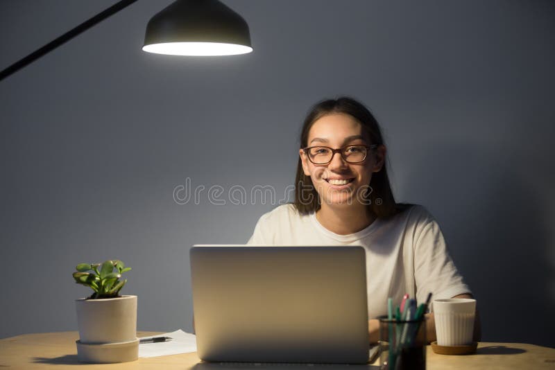 Glücklicher Freiberufler, der zur Kamera aufwirft am Schreibtisch lächelt lizenzfreies stockfoto Glücklicher Freiberufler, der zur Kamera aufwirft am Schreibtisch lächelt lizenzfreies stockfoto