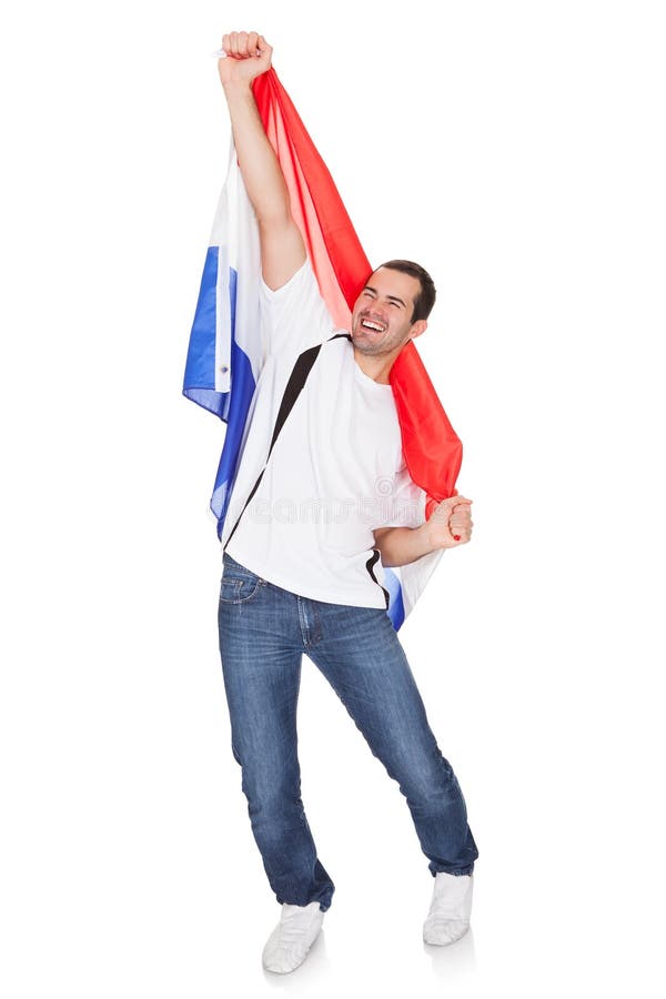 Glücklicher Mann, der eine niederländische Flagge hält stockfotografie