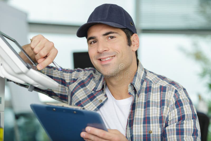 Happy technician next to printer machine man. Happy technician next to printer machine man