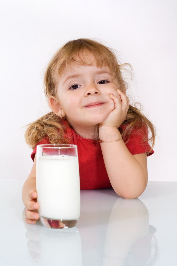 Glückliches kleines Mädchen mit Milch lizenzfreies stockfoto