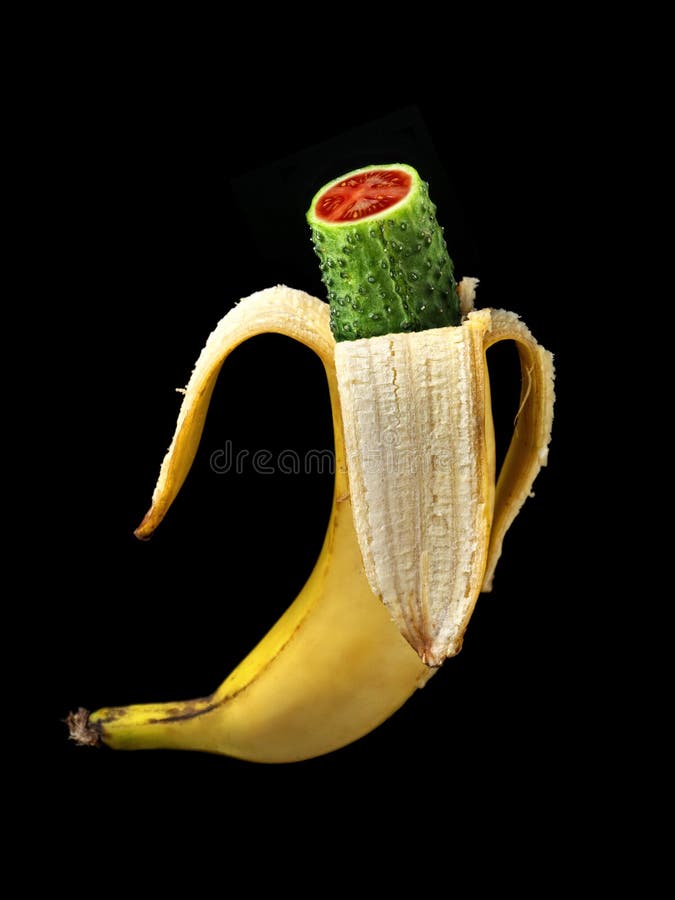 Hybrid of banana, green cucumber and tomato as GMO concept shot over black. Hybrid of banana, green cucumber and tomato as GMO concept shot over black