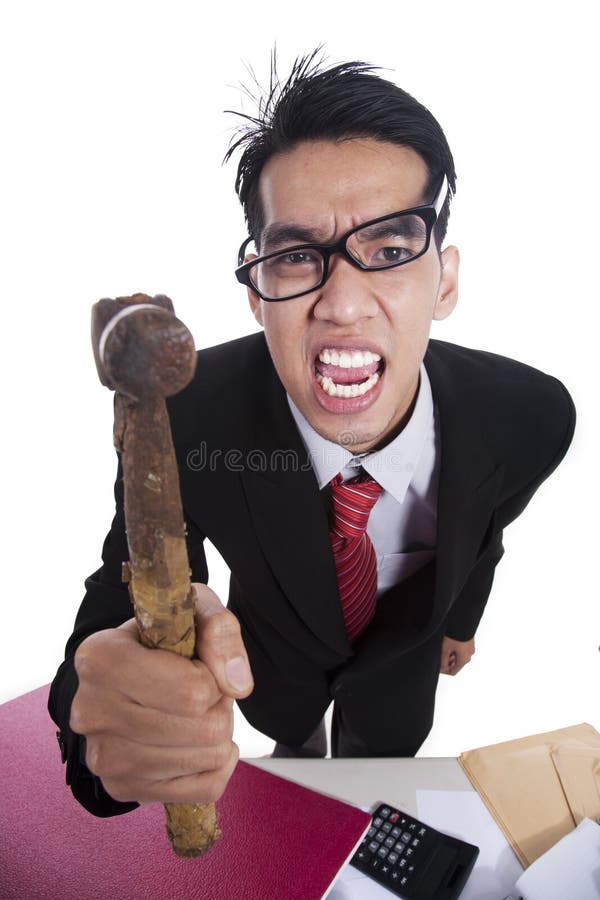 Angry Asian businessman with hammer isolated on white. Angry Asian businessman with hammer isolated on white