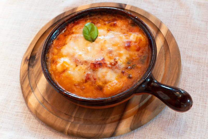 Gnocchi alla Sorrentina, Italian Potato Dumplings in Tomato Sauce, Gratinated With Mozzarella Cheese in a Terracotta Dish