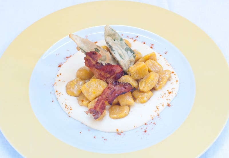 Gnocchi with Pumpkin and Peanut Butter and Crispy Bacon Stock Photo