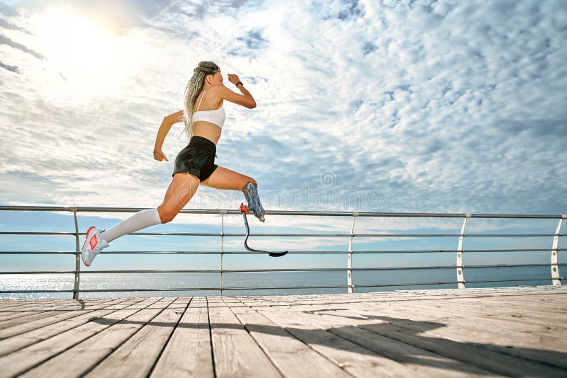 Premium Photo  Beautiful disabled athlete woman in sportswear with prosthetic  leg standing in yoga pose on bridge
