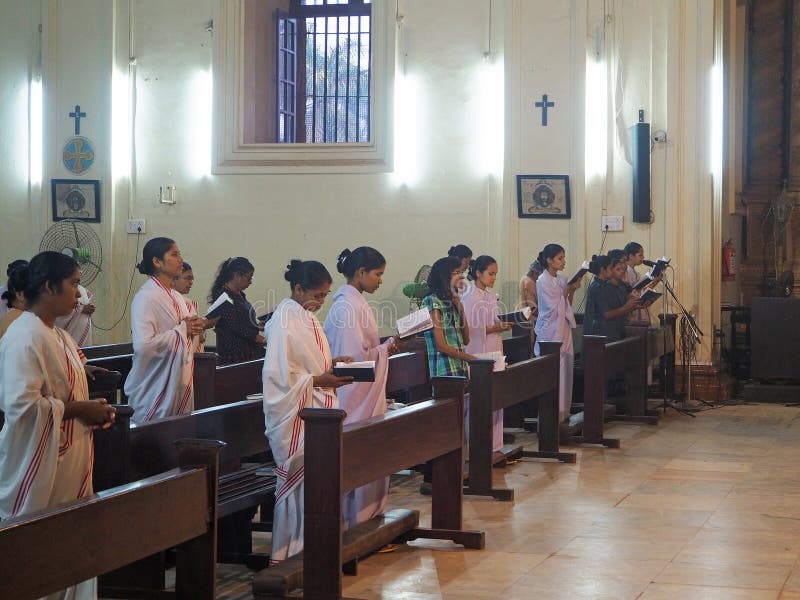Goa, India, 29.02.2020: People at a Church service read prayers at the Basilica of Bom Jesus church stock photo Goa, India, 29.02.2020: People at a Church service read prayers at the Basilica of Bom Jesus church stock photo
