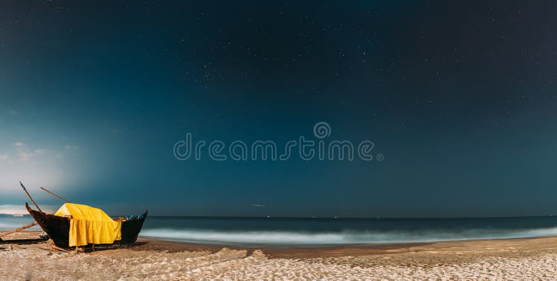 Goa, India. Real Night Sky Stars. Natural Starry Sky Blue Color Above Sea Seascape Ocean Beach. Background. Parked Old