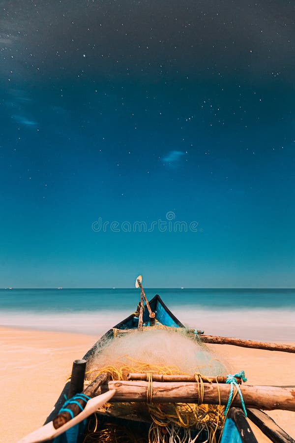 Goa, India. Real Night Sky Stars. Natural Starry Sky Blue Color Above Sea Seascape Ocean Beach. Background. Parked Old